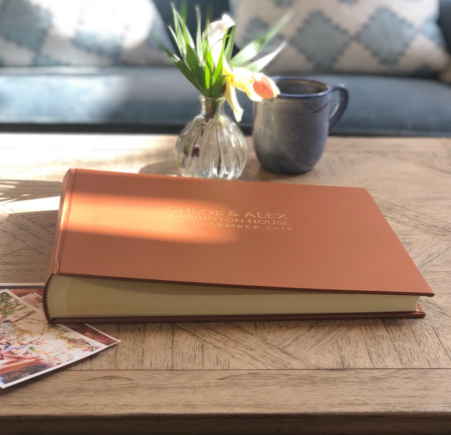 Light brown wedding guest book on coffee table