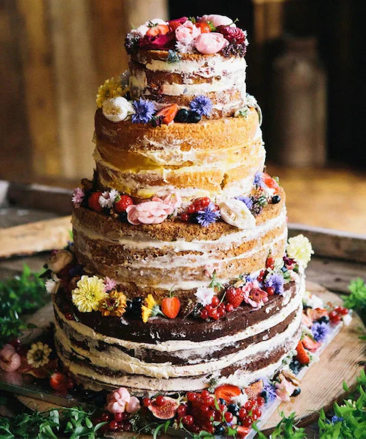 Beautiful 4 tier sponge wedding cake decorated with seasonal summer flowers