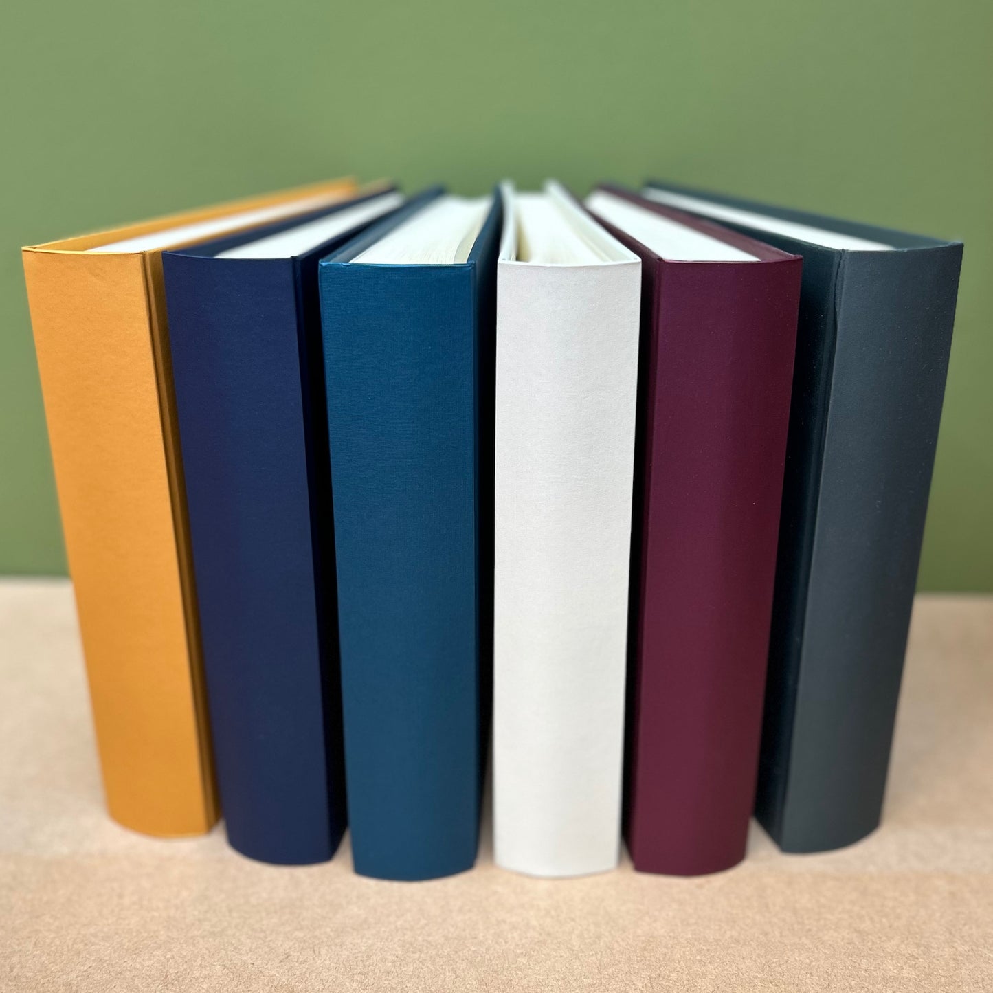 all of the six colour variations are shown here. Six photo albums are standing on their ends so you can see how the different colours look together 