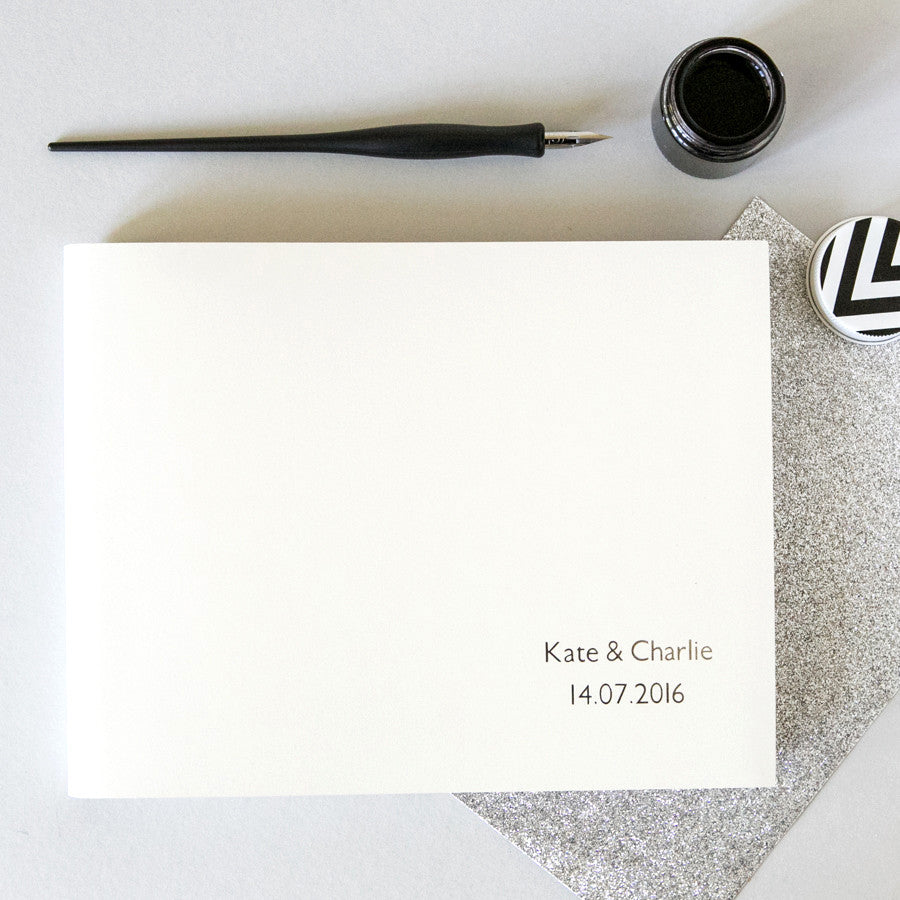 an ivory recycled leather guest book which has been personalised with two names and a date