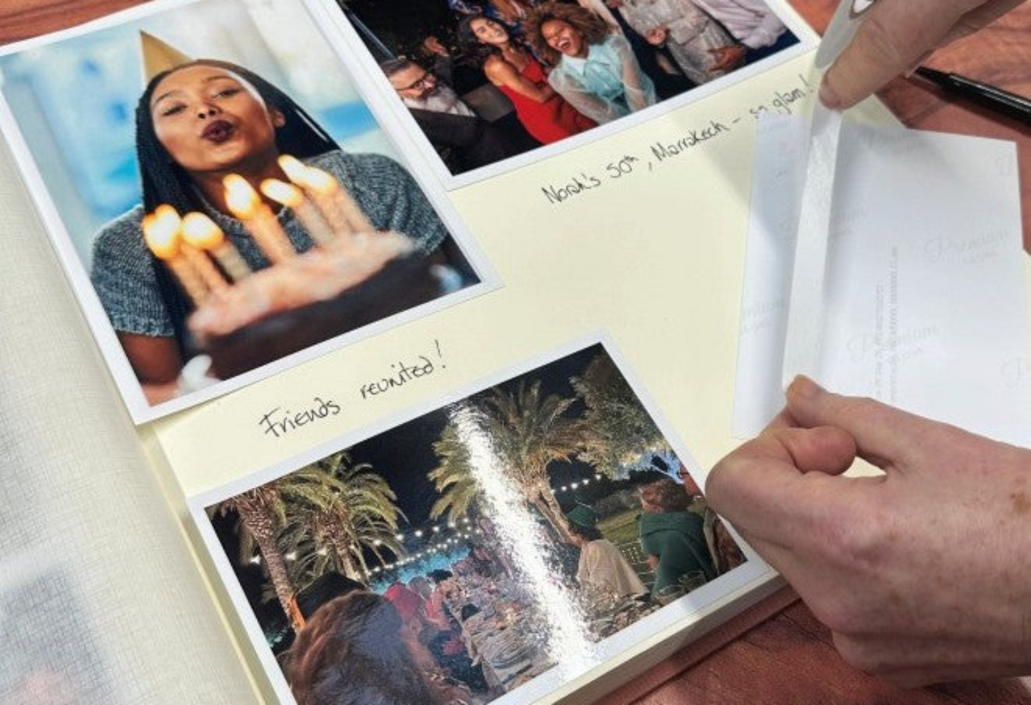 A woman sticks photos into a photo album.