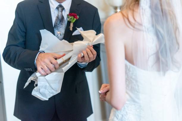 a couple opening a wedding gift on their wedding day