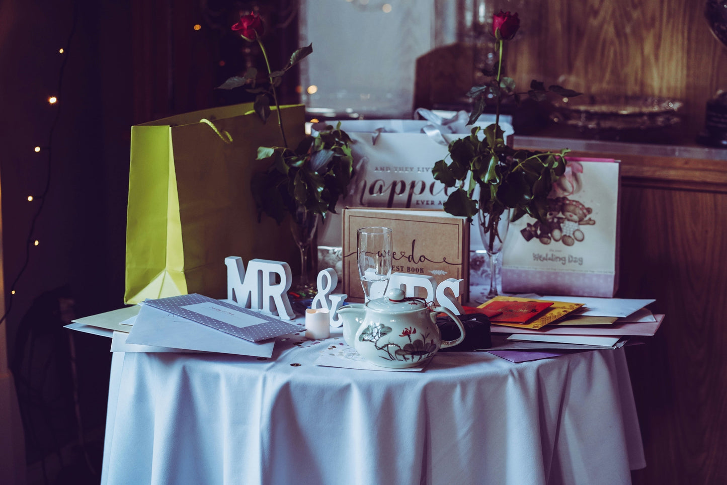 a table is piled high with wedding gifts