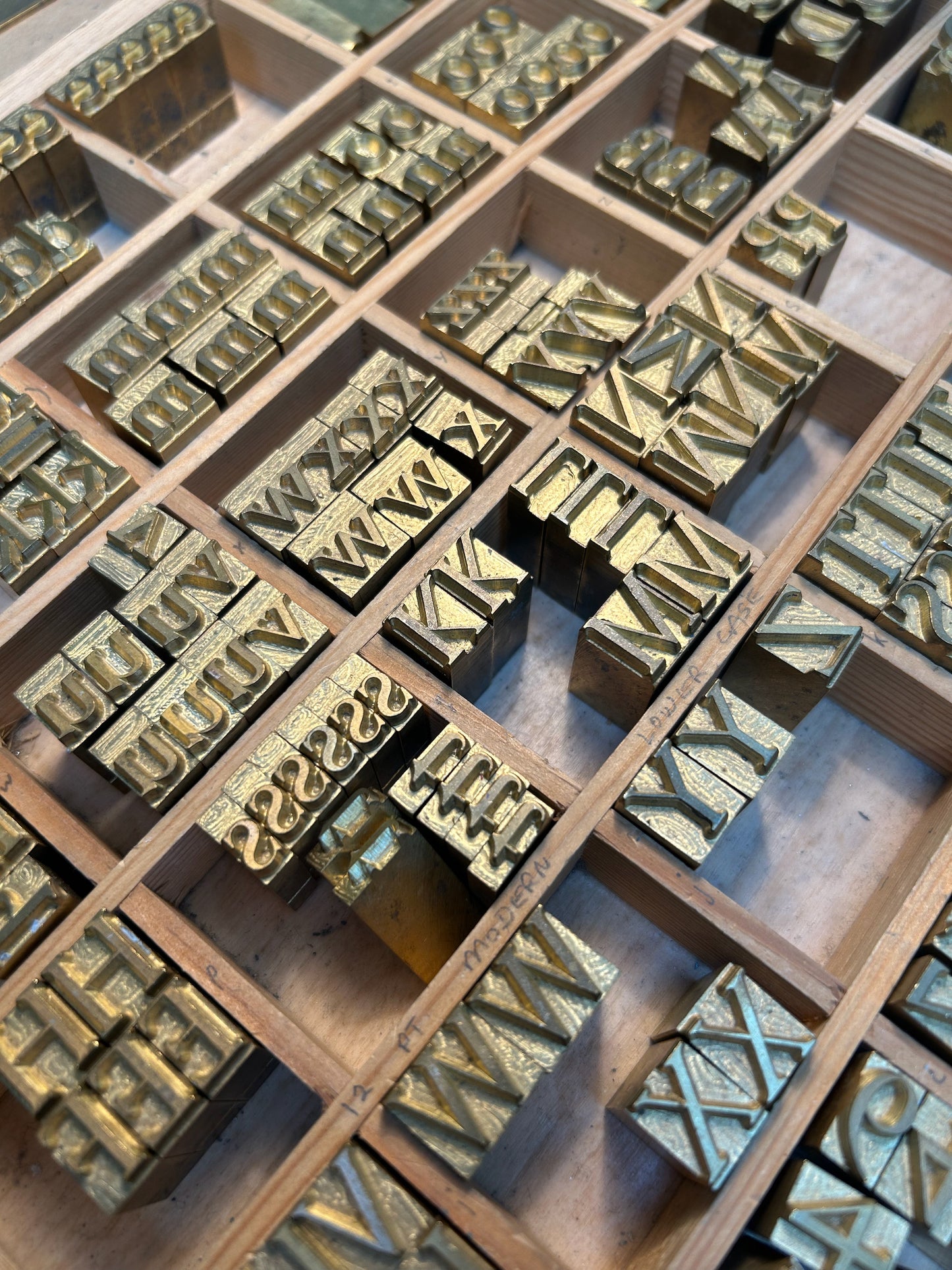A wooden grid containing letter printing blocks