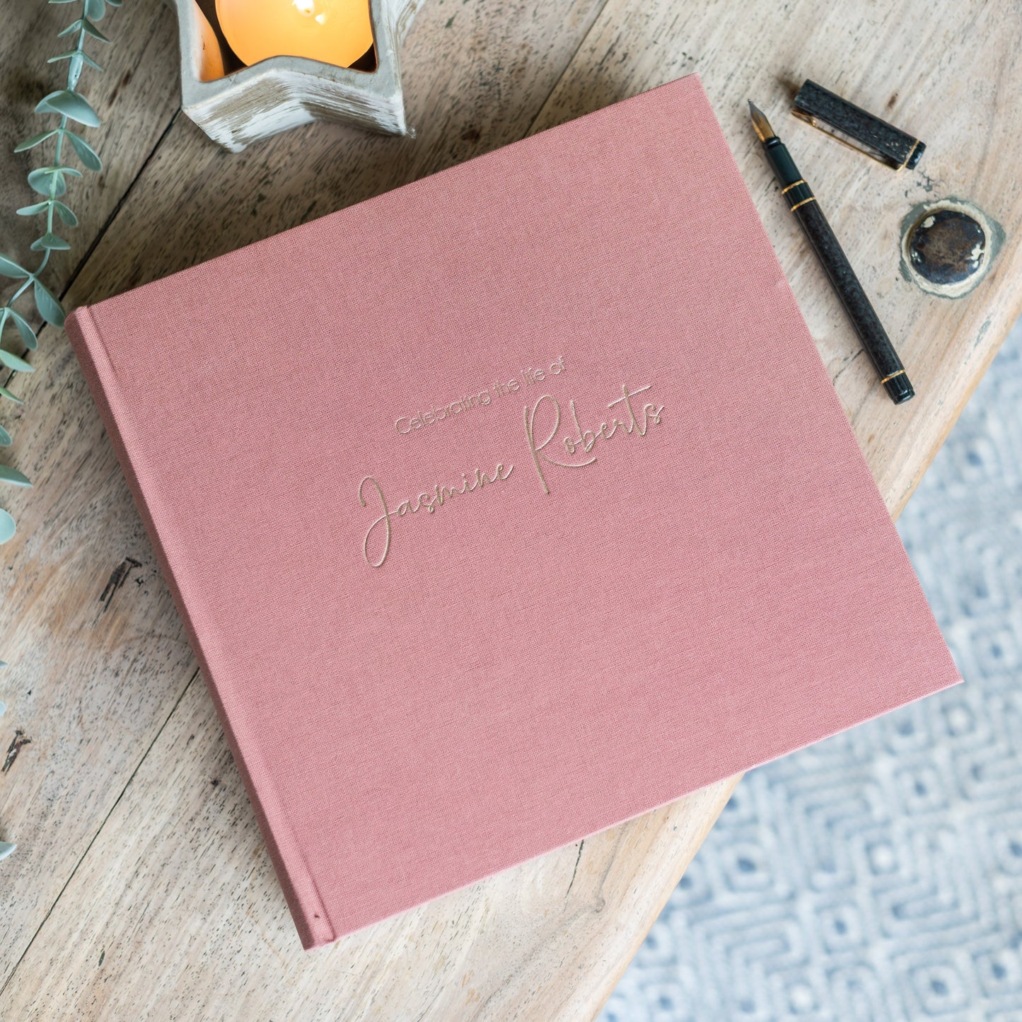 Antique Rose Condolence book personalised with 'Celebrating the life of Jasmine Roberts' embossed on the surface.