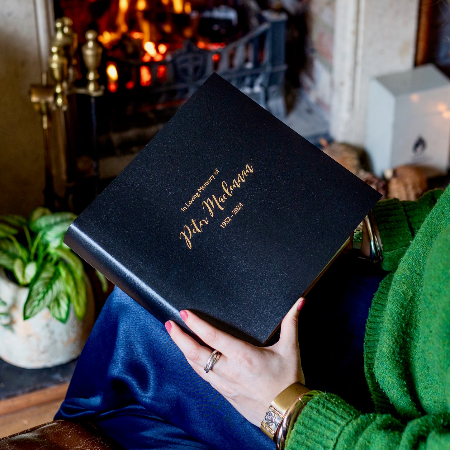 A black condolence book with gold embossed lettering on the front