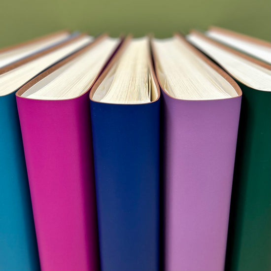 a fan of photo albums - pink, blue, purple and green