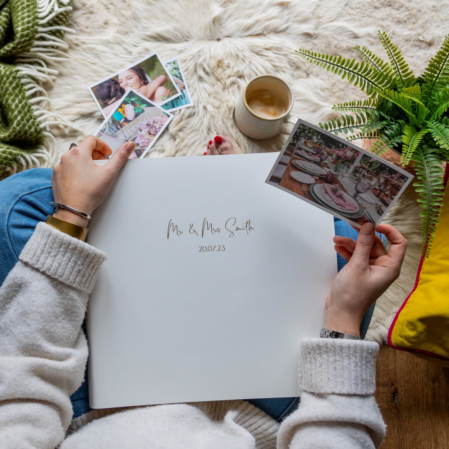 A lady about to start putting wedding photos into an ivory album