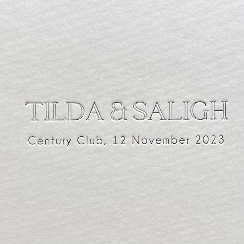 
                      
                        A close up of an embossed title taken from and ivory wedding album
                      
                    