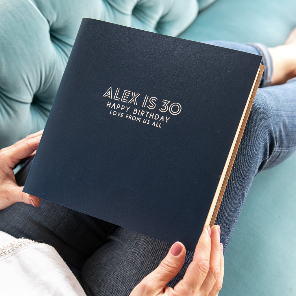 a lady about to look through a 30th birthday photograph album
