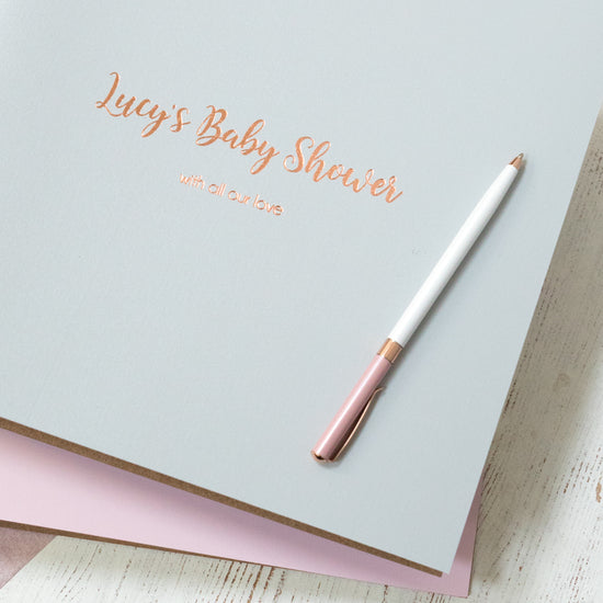 Load image into Gallery viewer, a close up image of a baby shower photo album showing you the personalisation on the front. A pen is on top of the album 
