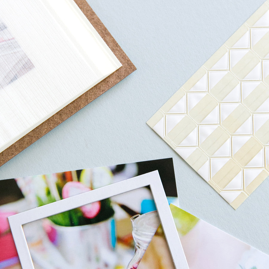 you can see mounting squares on the side of the table and then some photos showing you how you stick them into your photo album