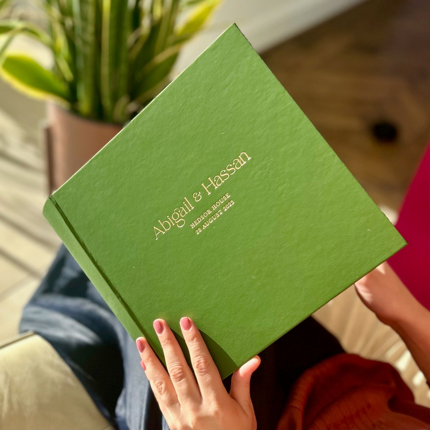 a woman is opening a wedding guest book and looking at the messages inside
