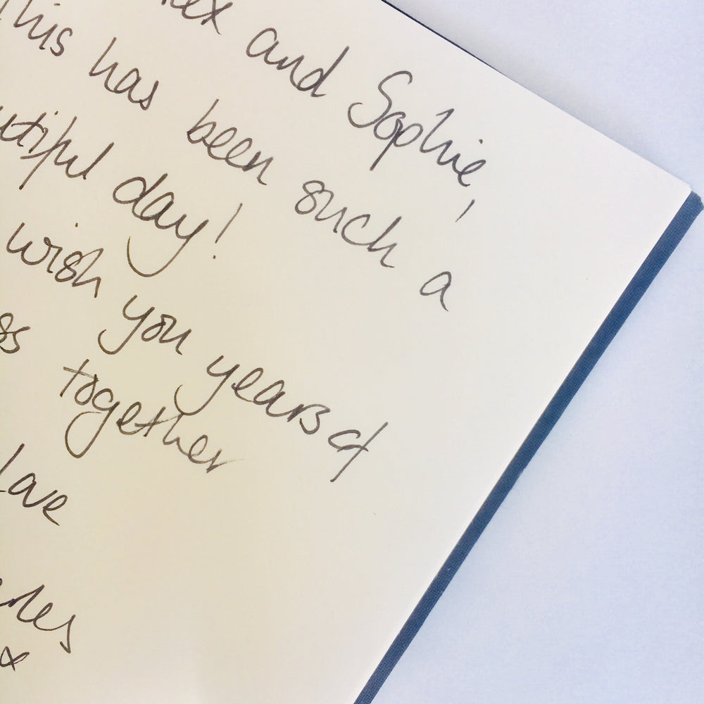 
                      
                        a message written inside the linen wedding guest book
                      
                    