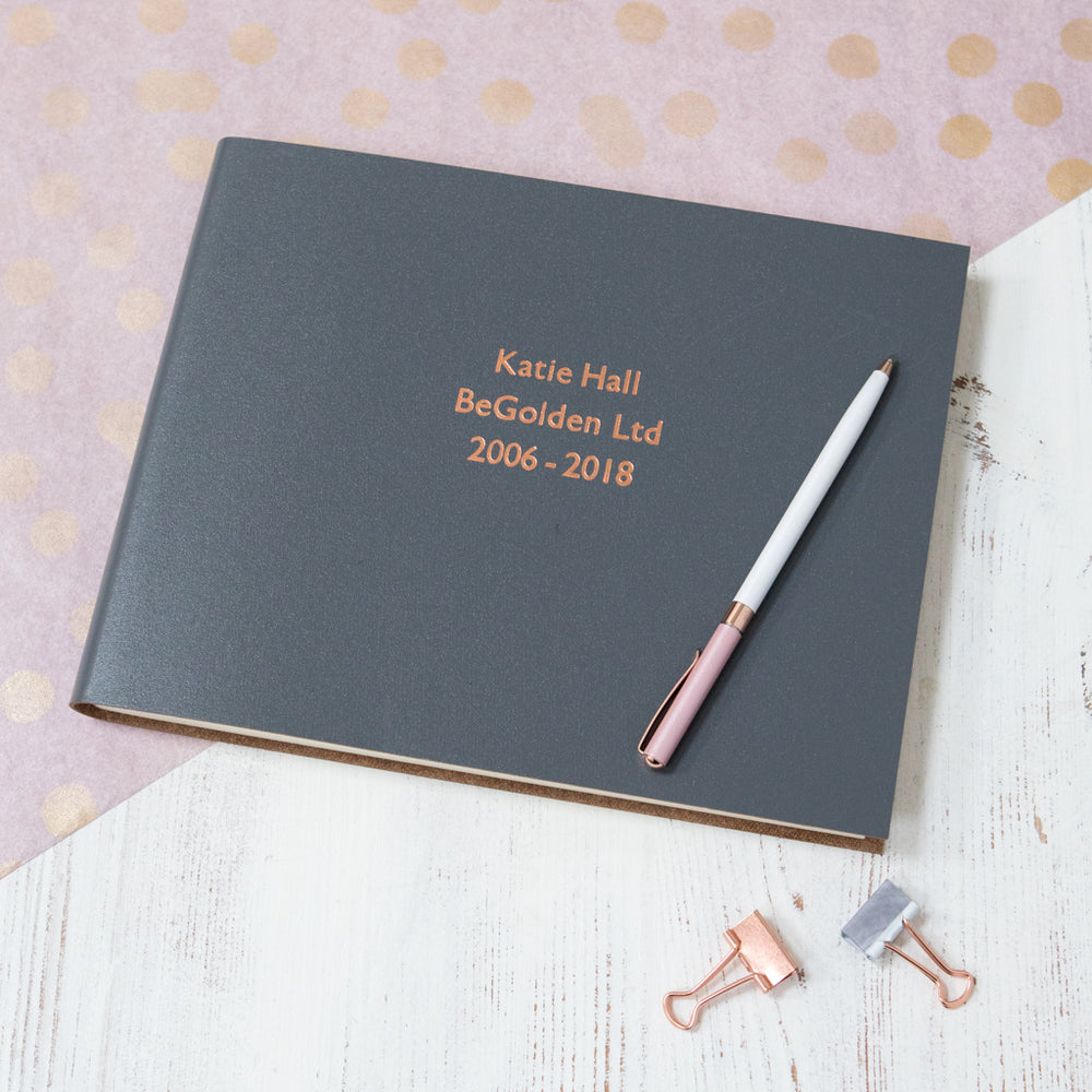 
                      
                        Another example of the leather leavers book - this time it is a charcoal grey book that has been printed with rose gold foil.
                      
                    