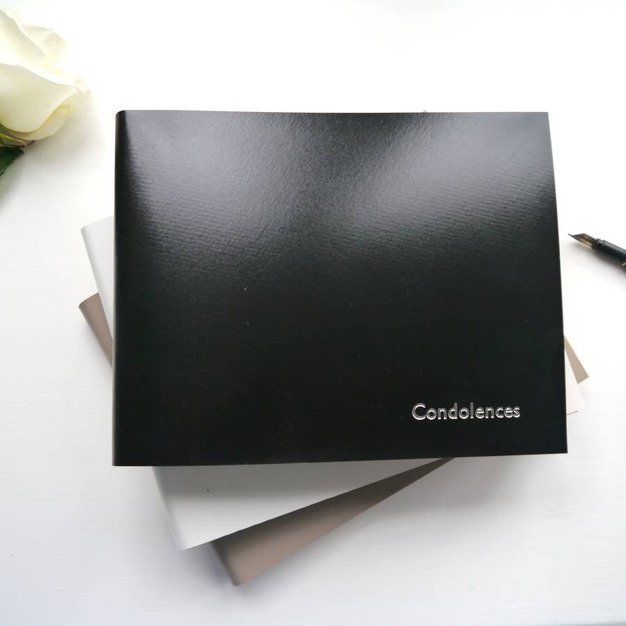 a black condolence book is ready for people to write messages in