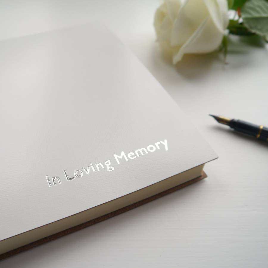 a close up picture of a white condolence book